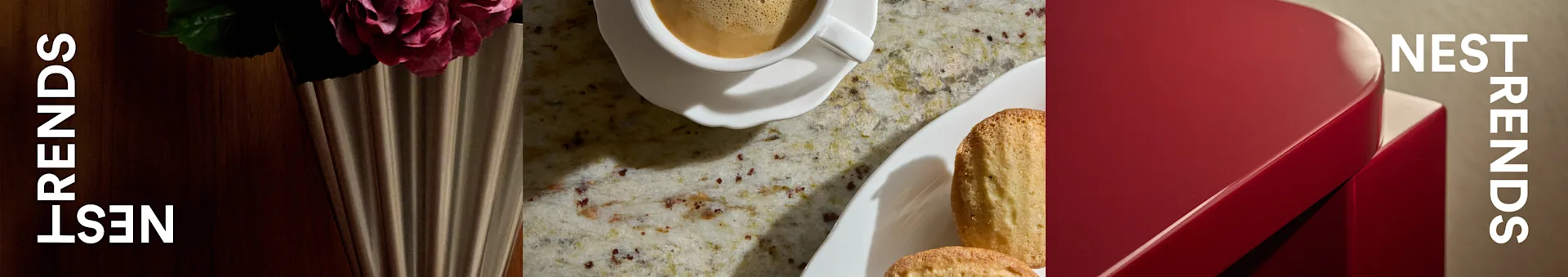 Kopje koffie, madeleines en roos in geribbelde vaas op gespikkelde aanrecht naast rode doos met 'NEST TRENDS'.