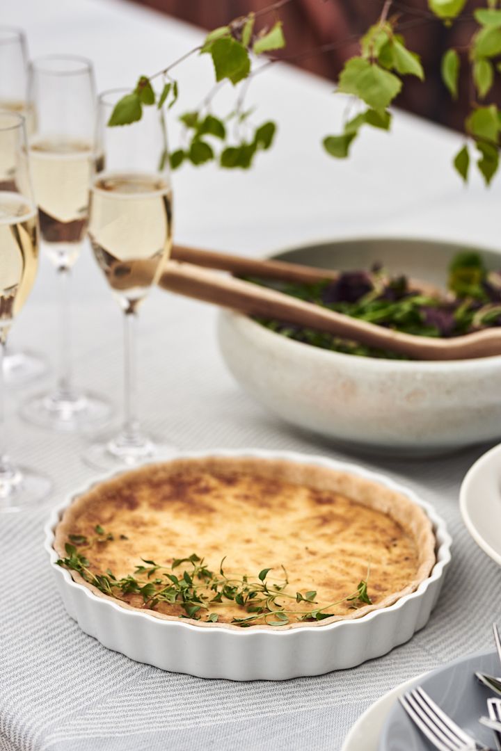 Een goede Västerbotten taart is een tip voor een eenvoudig buffetmaaltijd voor veel mensen, die kan worden geserveerd in een taartschaal van Pillivuyt samen met champagne in Karlevi champagneglazen van Scandi Living.