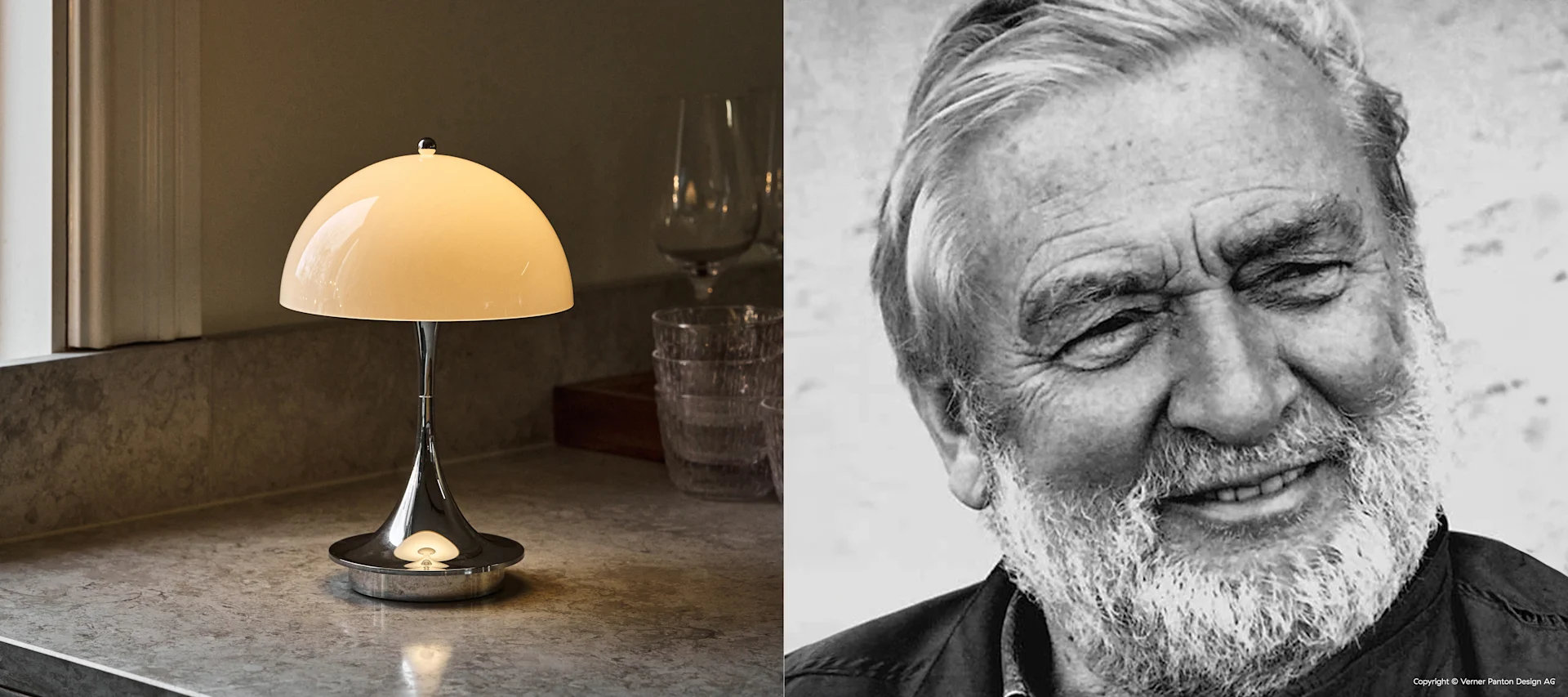 Witte koepellamp met zilveren voet op aanrecht, naast Z/W portret van lachende man met witte baard.